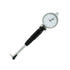 A dial indicator with a silver metal body, black grip, and white dial face, photographed on a plain white background.
