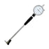 A dial indicator with a silver metal tube, black handle grip, and white measurement dial face, isolated on a white background.