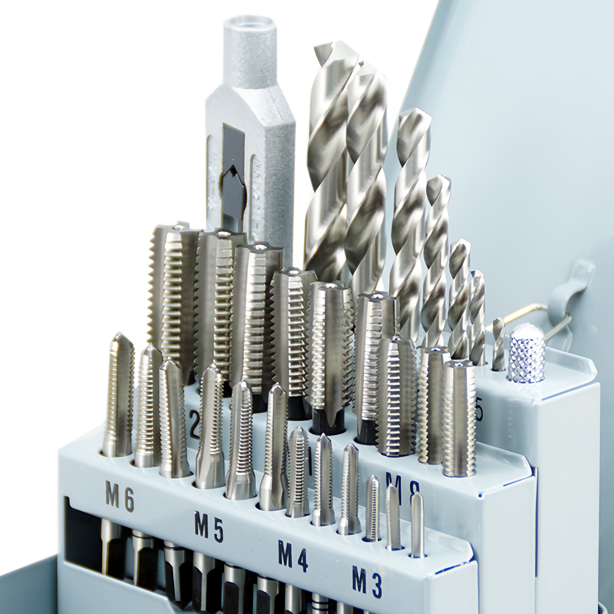 A set of high-speed steel (HSS) taps and drills organized in a case, with sizes labeled from M3 to M12.