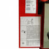 Close-up of a red machine panel with printed instruction sheets showing connection diagrams, labels, and a measurement table.