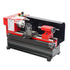 A SIEG Baby Lathe Model C0 with a red and black color scheme, featuring a lathe tool post, chuck, and tailstock.