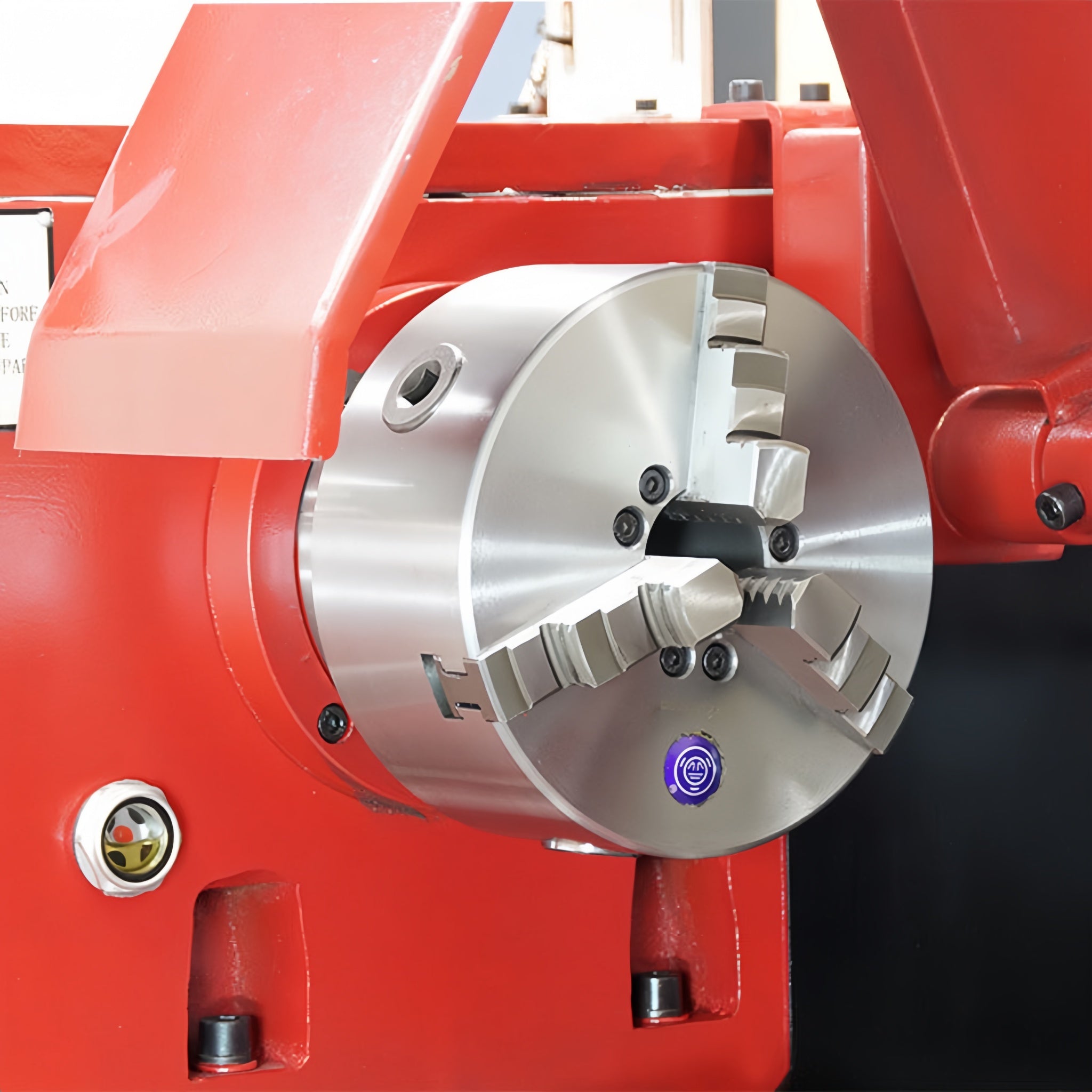 Close-up of a red machine tool with a metallic component