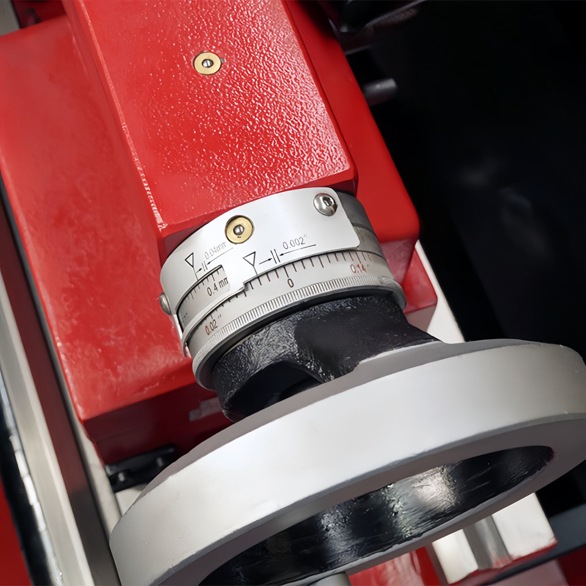 Close-up of a mechanical component with a red housing and metal parts.