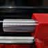 Close-up of a red tool with a metallic component on a blurred background