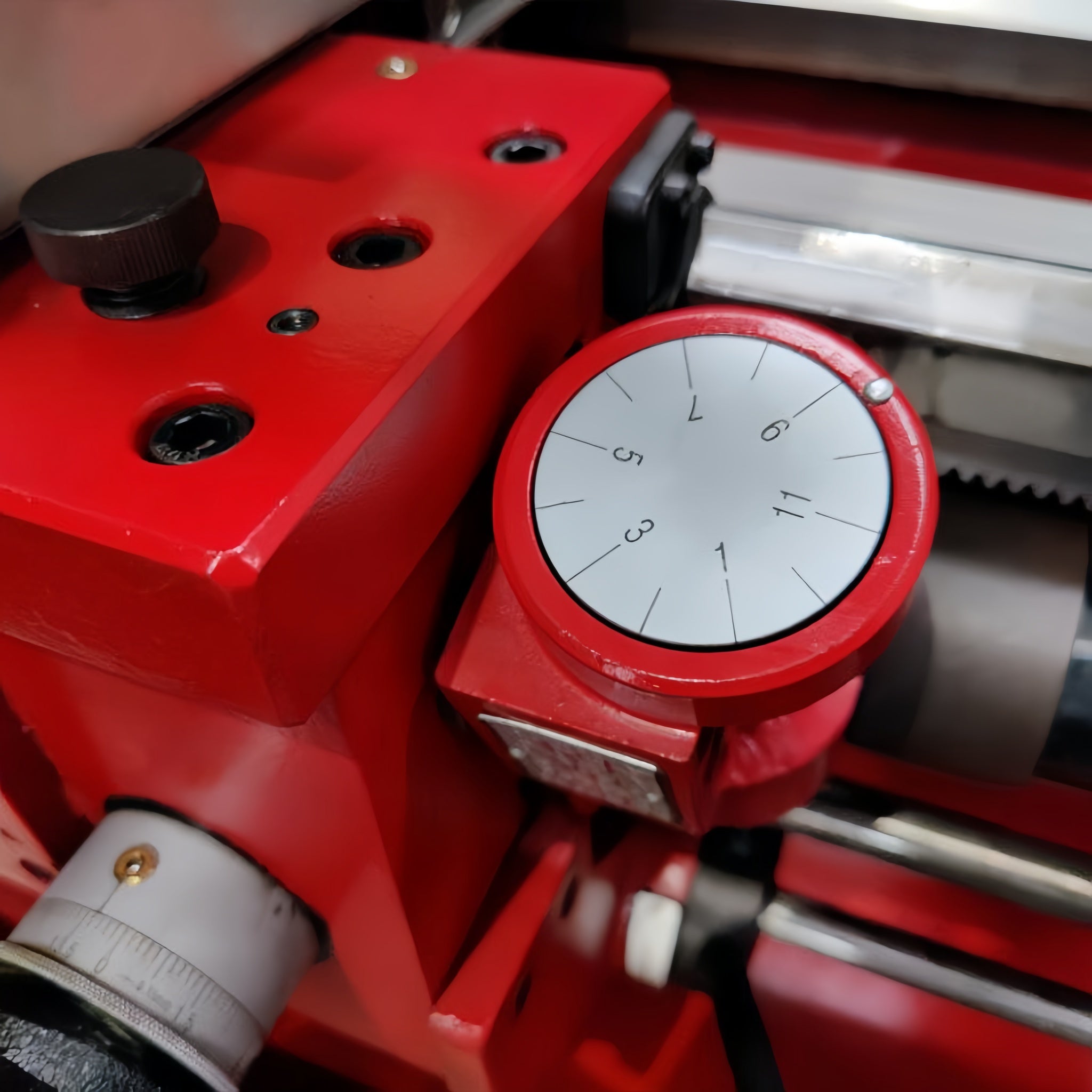 Red mechanical device with a dial on a blurred background