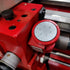 Red mechanical device with a dial on a blurred background