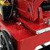 Close-up of a red metalworking machine with a scale on a white background