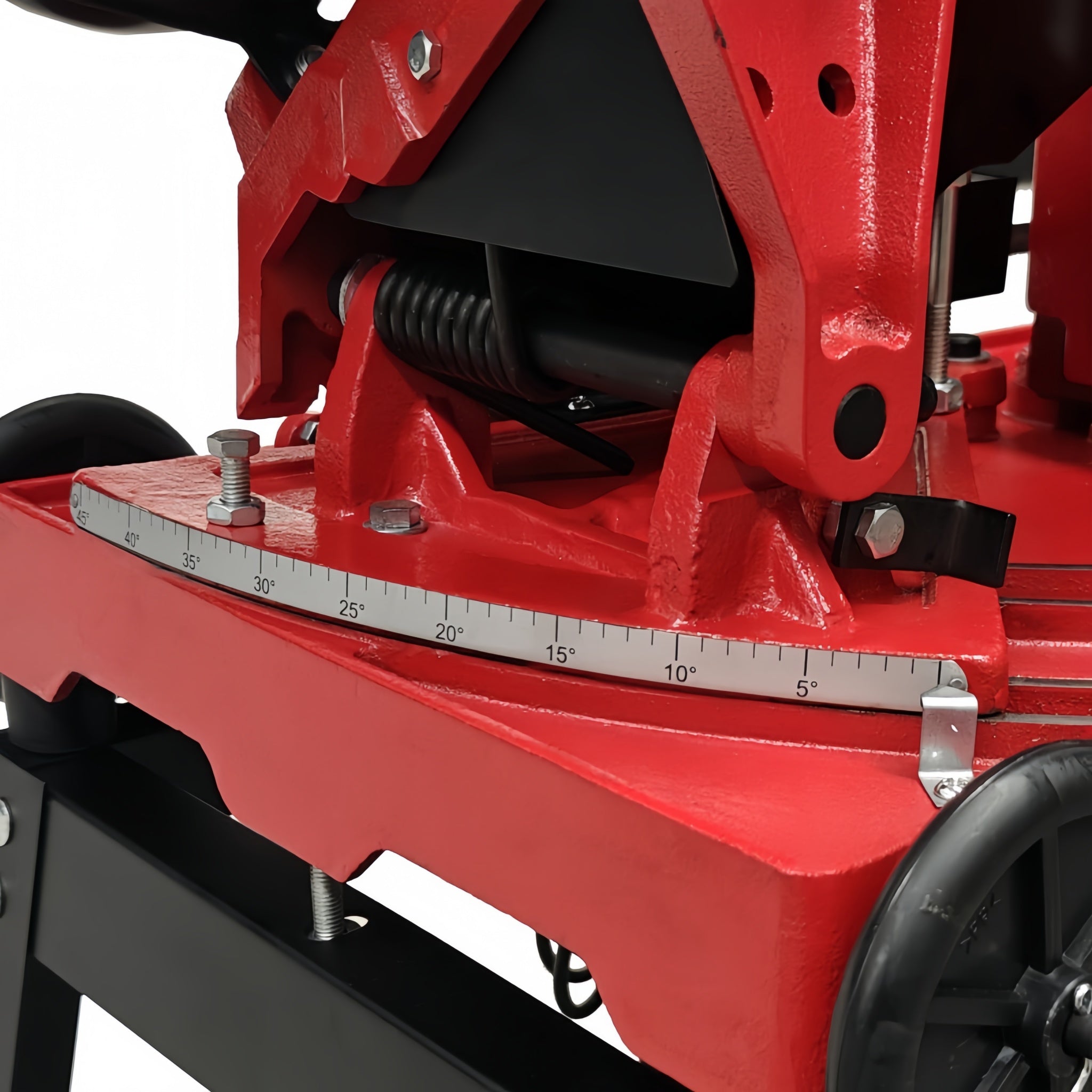Red metal machine with a ruler attached on a white background