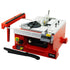 A red mini table saw with gray and black components, including a blade and adjustment knobs, on a white background.