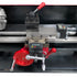 A close-up of a metal lathe machine headstock and carriage assembly with red adjustment handles, silver metal rods, and small digital control screens on a black machine bed.