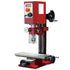 Red and silver drill press on a white background